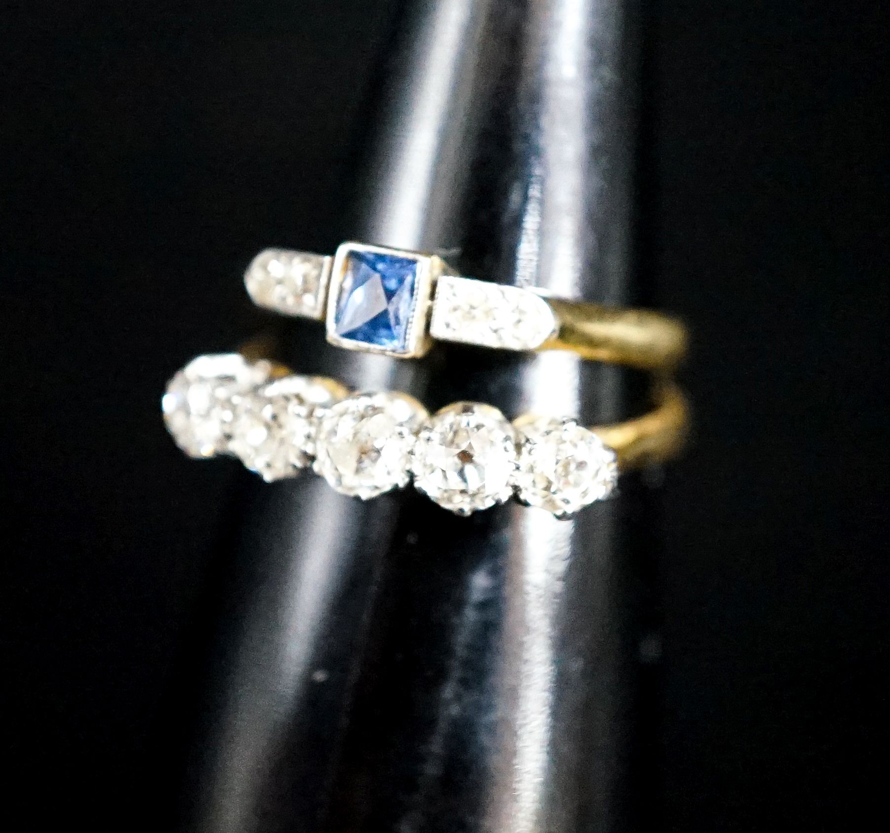 An 18ct and five stone diamond ring and a similar sapphire and diamond ring (now soldered together), gross 4.2 grams.